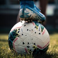 white and blue soccer ball on green grass field